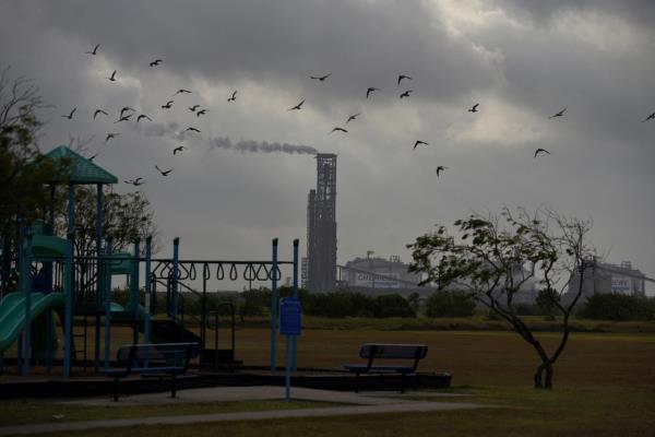 A portion of the Cheniere Texas LNG facility is seen from a playground
