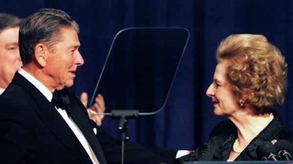 Former British Prime Minister Margaret Thatcher (R) shakes hands with former US President Ronald Reagan as she participates in a birthday salute celebrating Reagan's 83rd birthday, February 3 in Washington