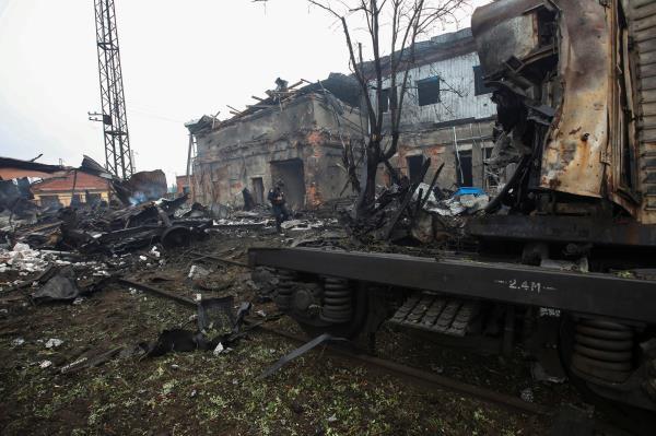 Police officer inspects the site of a Russian missile strike at a railway cargo terminal in Kharkiv