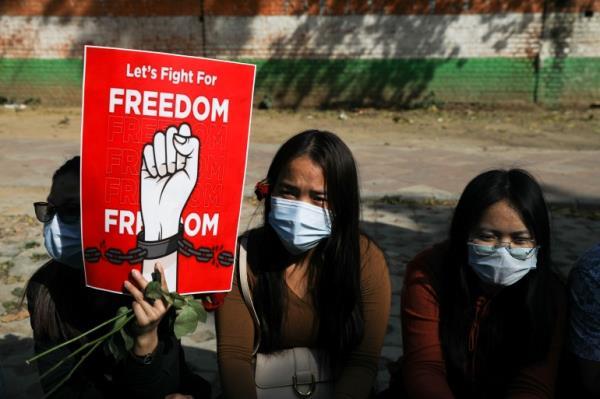 Myanmar citizens living in India hold a placard as they attend a protest, organised by pro-democracy supporters, against the military coup in Myanmar 