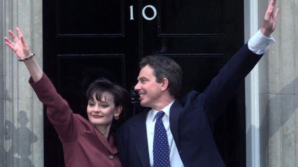 New Prime Minister Tony Blair waves with his wife Cherie on the doorstep of Number 10 Downing Street after winning a landslide election victory May 2. This was the first time in 18 years that the Labour Party has been in power. BRITAIN ELECTION