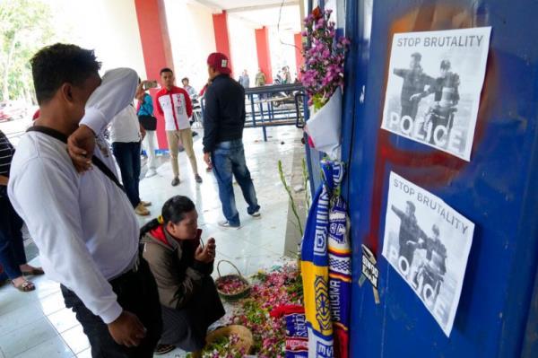 A man breaks down at a memorial for the victims of Saturday's soccer match stampede in front of gate 13 at the Kanjuruhan Stadium in Malang, Indonesia on Oct 4, 2022 