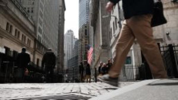 People walk by the New York Stock Exchange (NYSE) on April 04, 2022 in New York City. 