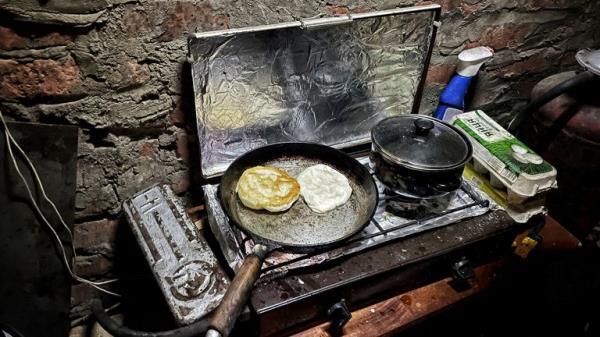 Natalia is cooking in a basement