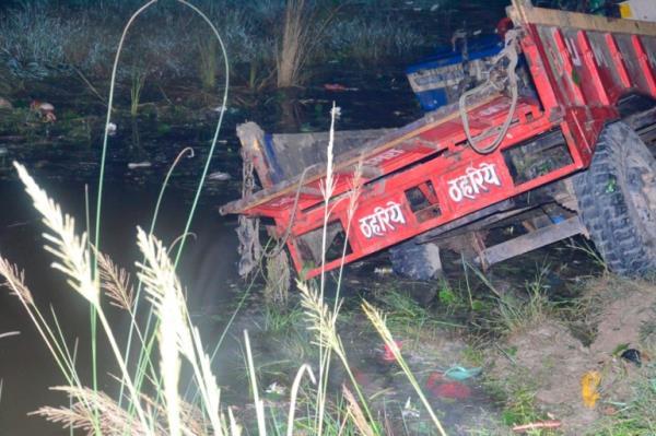 A farm tractor is seen fallen in a pond in Ghatampur area of Kanpur