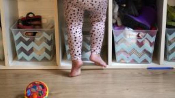 A preschooler gets up on her toes to reach into her assigned cubby at a preschool center Monday, Oct. 25, 2021, in Mountlake Terrace, Washington. 