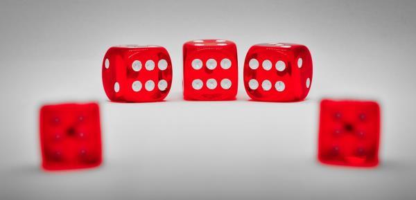 Close-Up Of Red Dice On Table