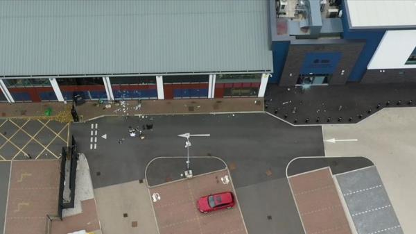 An aerial shot shows debris on the ground outside the station and what appears to be a smashed window 
