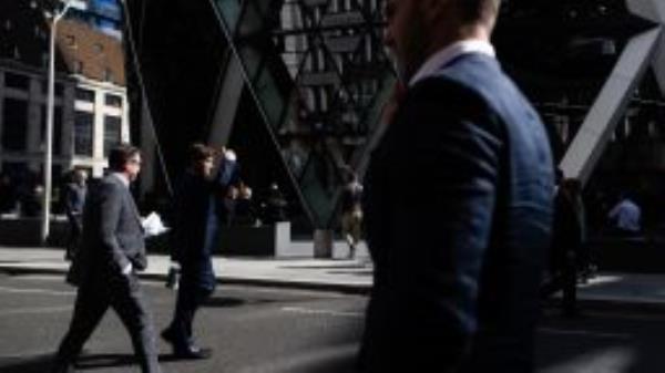 City workers pass the 30 St. Mary Axe skyscraper, also known as The Gherkin, at lunchtime in the City of London, UK, on Thursday, Sept. 29, 2022. The pound snapped a two-day gain and UK government bonds dropped as Prime Minister Liz Truss defended her package of sweeping tax cuts, stoking investor concerns over the countrys fiscal credibility. 