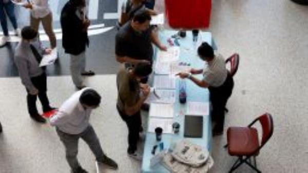 Angela Perry (R), a recruiter for Cox Media Group, helps people looking for work during the Mega Job Fair held at the FLA Live Arena on June 23, 2022 in Sunrise, Florida.