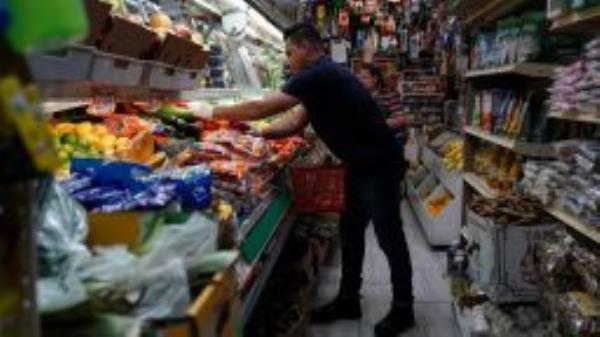 A person arranges groceries in El Progreso Market in the Mount Pleasant neighborhood of Washington, D.C., U.S., August 19, 2022. 