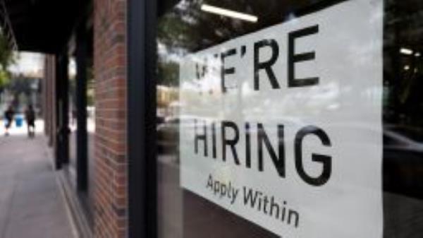 A hiring sign posted on the window of a retail store in Washington, D.C., on Aug. 5, 2022.