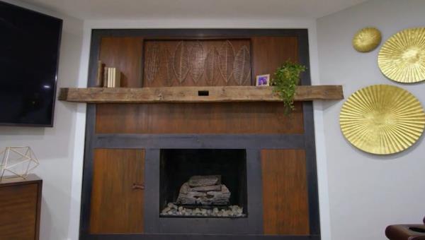 metal fireplace with wood mantle