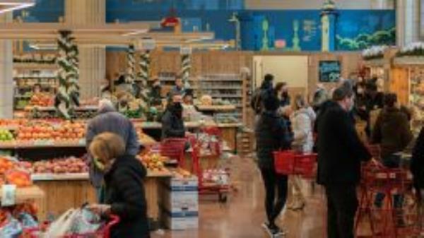 Customers shop at the Trader Joe's Upper East Side Bridgemarket grocery store in New York, U.S., on Thursday, Dec. 2, 2021.