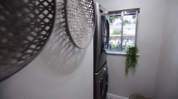 Smaller laundry room with stacked washer and dryer