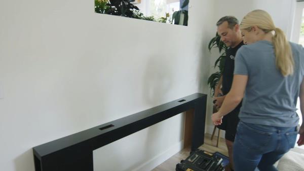 Jasmine installs a custom console table behind the couch area on "Help! I Wrecked My House"