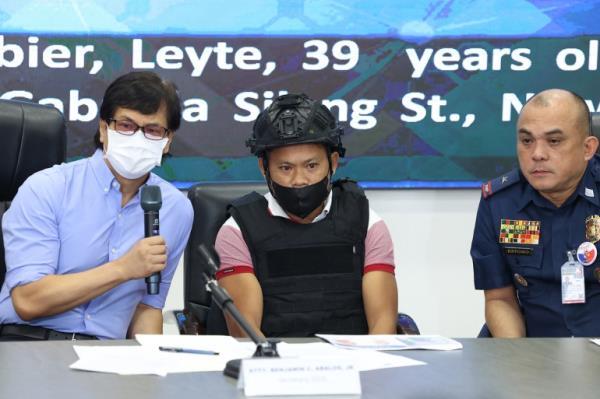 Joel Estorial (centre), the alleged gunman in the killing of Philippine journalist Percival Mabasa, is presented to the media on October 18, 2022 