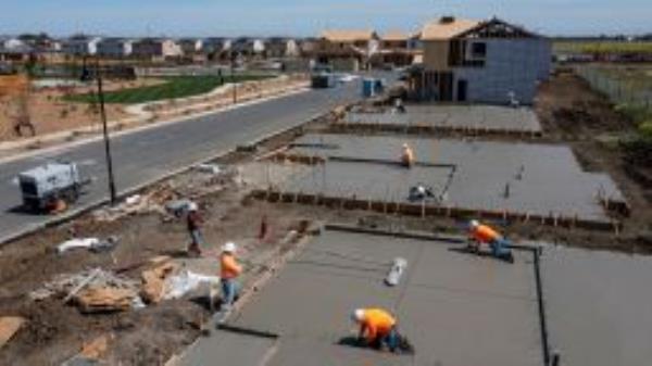 Contractors work on concrete slabs in the Cielo at Sand Creek by Century Communities housing development in Antioch, California, U.S., on Thursday, March 31, 2022. 