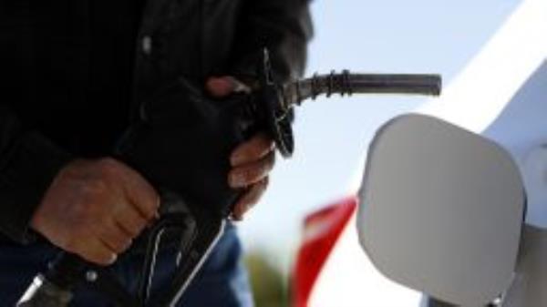 A customer fills up with gasoline at a gas station, Monday, Oct. 3, 2022, in Erlanger, Ky. 