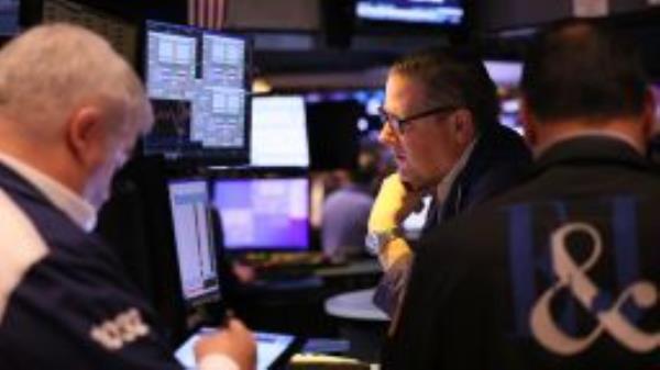 Traders work on the floor of the New York Stock exchange during morning trading on October 18, 2022 in New York City. 