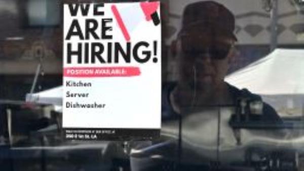 A "We Are Hiring" sign is posted in front of a restaurant in Los Angeles, California on August 17, 2022. (Photo by FREDERIC J. BROWN/AFP via Getty Images)