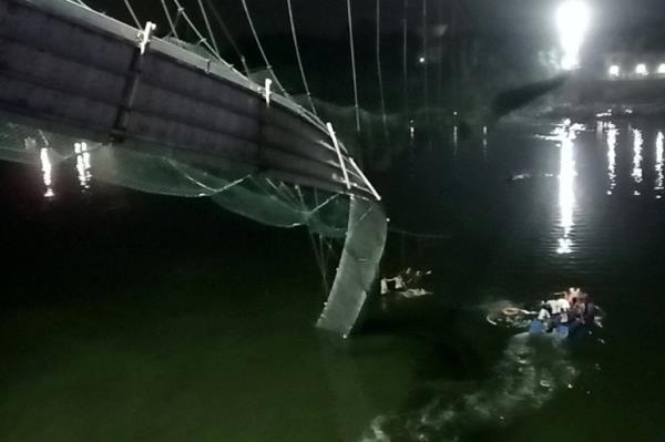 A view shows a damaged part of a suspension bridge after it collapsed in Morbi town in the western state of Gujarat