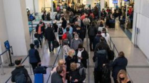 Passengers wait in line inside the terminal at Newark Liberty International Airport in Newark, New Jersey, U.S., November 24, 2021. REUTERS/Eduardo Munoz