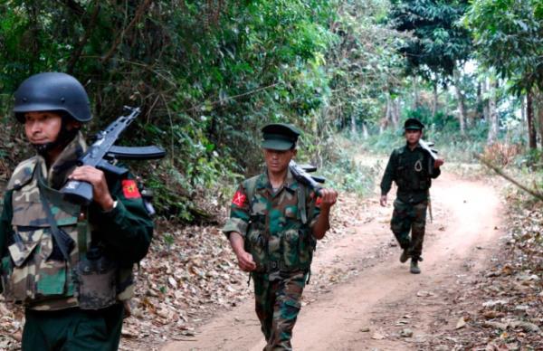 In this March 17, 2018 photo, Kachin Independence Army fighters walk in a jungle path in northern Kachin state, Myanmar.