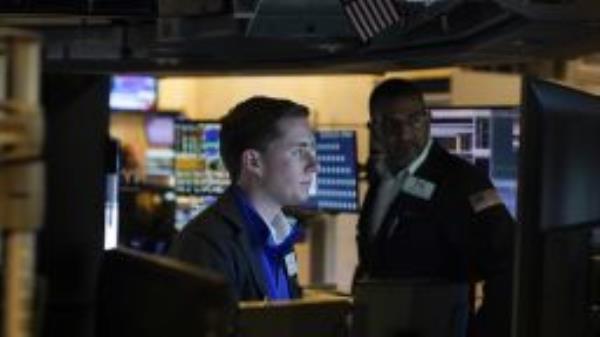 Traders work on the floor at the New York Stock Exchange in New York, Tuesday, Oct. 4, 2022. 
