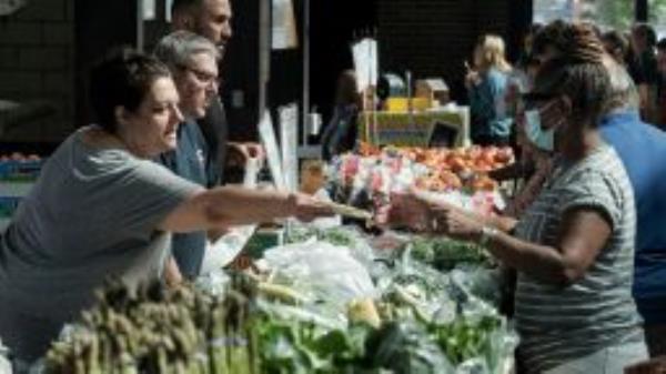 Customers shop for produce at the Eastern Market in Detroit, Michigan, US, on Saturday, Sept. 17, 2022. Despite slowing inflation and falling gas prices in August, US shoppers felt little relief as higher food bills forced many to recalibrate their spending patterns. 