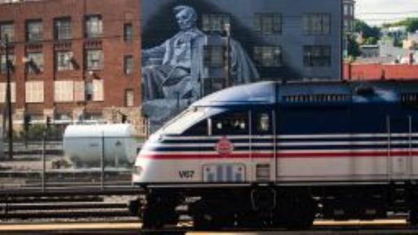 A train is seen near a mural of Abraham Lincoln is seen in the Eckington neighborhood of Washington, D.C., on Monday, August 22, 2022.