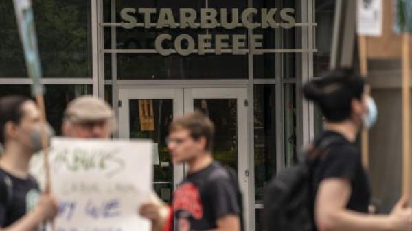 Demonstrators protest outside a closed Starbucks location in Seattle in July.