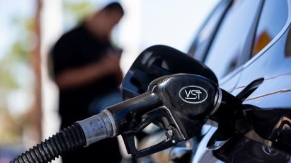 A man refuels his car at gas station in Carson, California, on September 22.