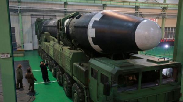 North Korea Hwasong-15 misslle on a transporter with Kim Jong Un looking at it
