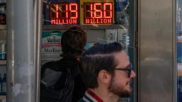 A person looks at a digital billboard advertising Powerball's Jackpot of 1.6 billion dollars in New York City, U.S., November 4, 2022. REUTERS/David 'Dee' Delgado