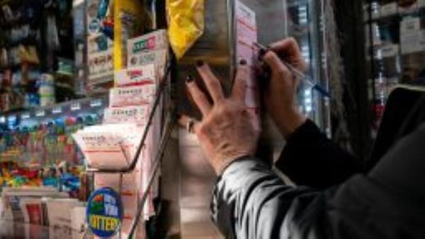 A person fills out a Powerball play slip for the 1.6 billion dollar jackpot in New York City, U.S., November 4, 2022. 