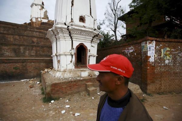 A man walks past damaged temples after an earthquake in Bhaktapur, Nepal in 2015 