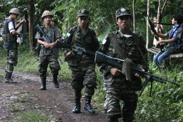 In this file photo, Moro Islamic Liberation Front (MILF) fighters patrol Ginanta village in southern Basilan island in 2007 