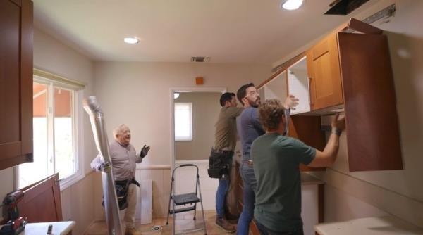 Carefully removing cabinets to donate