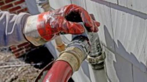 Corey Carlson of Anderson Fuel fills a house with home heating oil which has risen to over $5.00 a gallon on March 8, 2022 in Scituate, Massachusetts.  