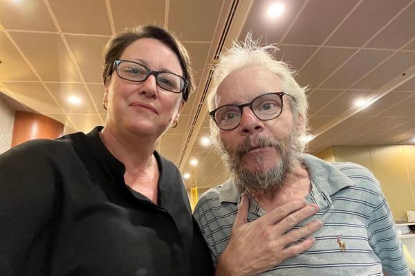 Sean Turnell stands on the right, looking relieved, with Australia's charge d'affaires in Myanmar after being released from Insein prison