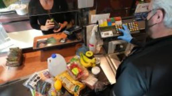 A cashier assists a customer at a checkout counter at Harmons Grocery store in Salt Lake City, Utah, U.S., on Thursday, Oct. 21, 2021.  