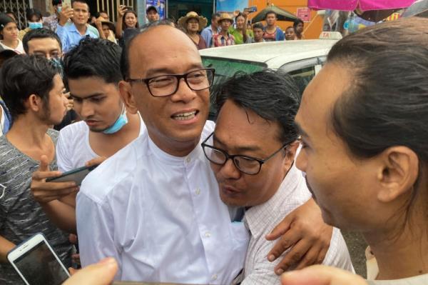 Mya Aye hugging his colleague and smiling as he is released from prison. Everyone else looks happy too