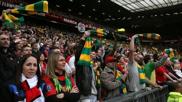 Man United fans wave green and gold scarves in protest at the Glazers in 2010