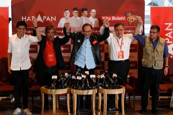 Anwar stands with the leaders of the parties that make up PH after the Nov 19 election. They all have their arms raised in the air and look happy