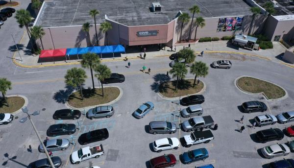 People arrive to receive Covid-19 shots at a vaccination site in a former Sears store at the Lake Square Mall on the first day that adults in Florida of any age became eligible to be vaccinated, in Leesburg, Florida, on April 5, 2021.