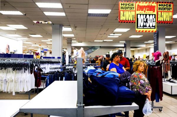 Shoppers wait in line by an empty rack of jeans during a Black Friday sale at a Sears store in Hialeah, Florida, on November 29, 2019. 