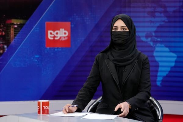 Khatereh Ahmadi a TV anchor wears a face covering as she reads the news on TOLO NEWS, in Kabul, Afghanistan, Sunday, May 22, 2022. Afghanistan's Taliban rulers have begun enforcing an order requiring all female TV news anchors in the country to cover their faces while on-air. The move Sunday is part of a hard-line shift drawing condemnation from rights activists.
