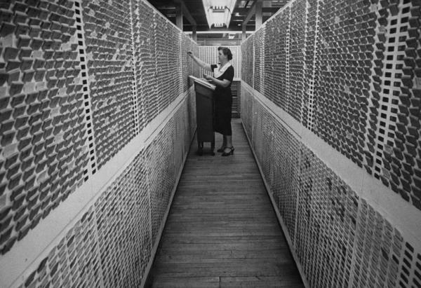 A worker goes over files in Sears' catalog office.