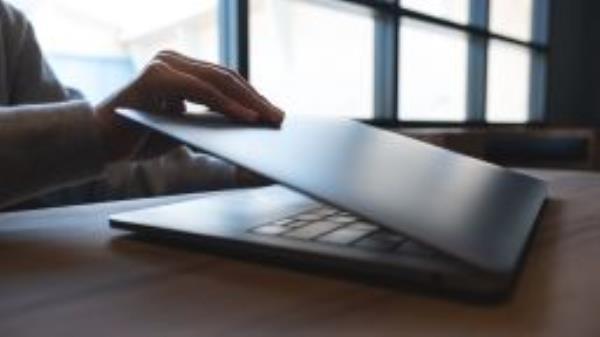 Office worker closing laptop STOCK